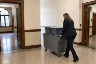 Empty civic corridor divides toward two unmarked courtrooms