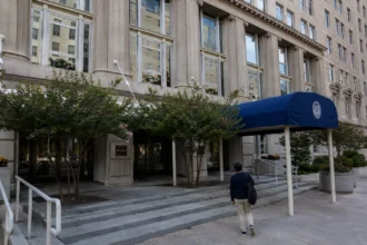 Visitor approaching a Department of Veterans Affairs building, editorial illustration